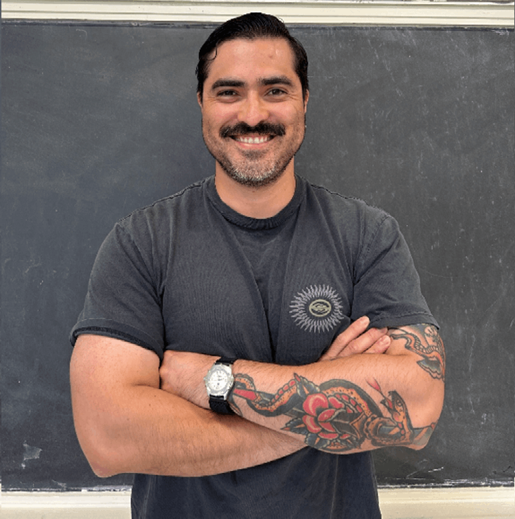 Man in grey shirt with his arms crossed